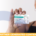 Medical Mutual member holding up health insurance card